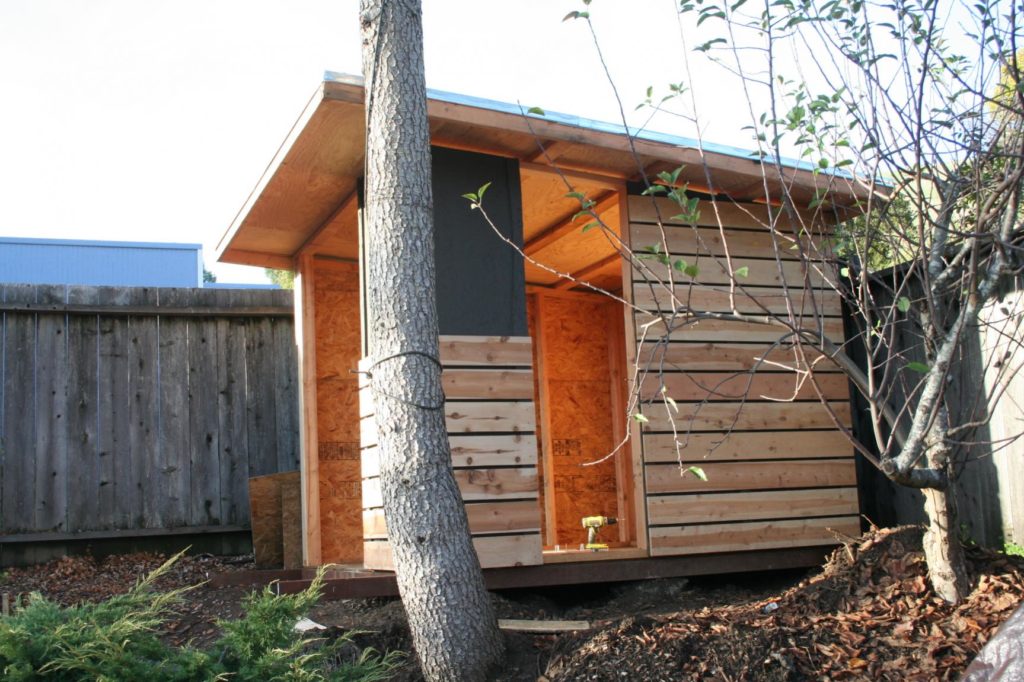 used two scraps of the fence wood and a level to install each siding 